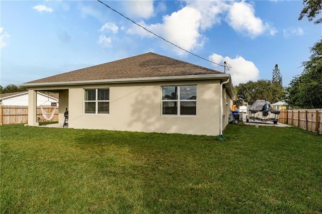 rear view of property with a yard