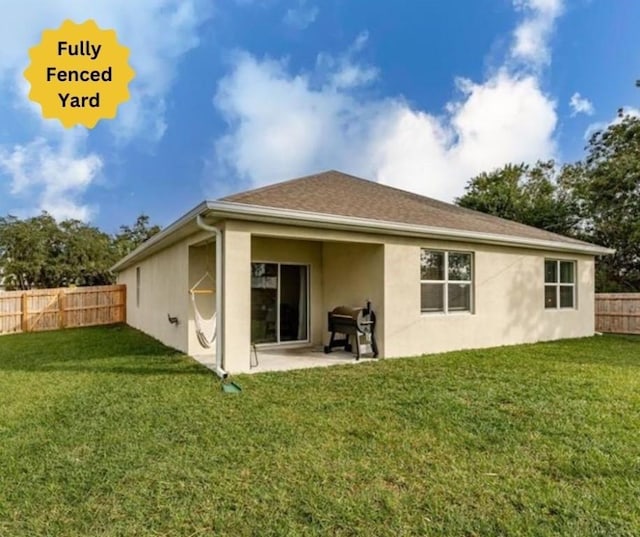 back of house featuring a lawn and a patio