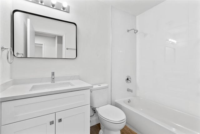 full bathroom with toilet, vanity, wood-type flooring, and washtub / shower combination