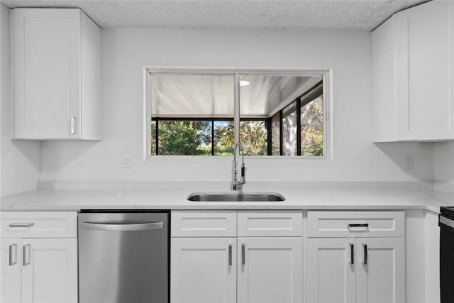 kitchen with stainless steel dishwasher, white cabinets, and sink