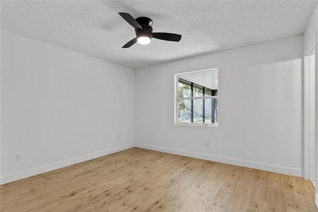 empty room with a textured ceiling, light hardwood / wood-style flooring, and ceiling fan