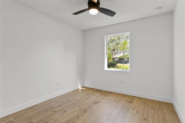 spare room featuring ceiling fan, a textured ceiling, and light hardwood / wood-style flooring