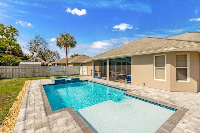 view of pool with an in ground hot tub, a sunroom, and a patio