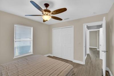 unfurnished bedroom featuring ceiling fan, hardwood / wood-style floors, and a closet