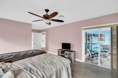 bedroom with ceiling fan, dark hardwood / wood-style flooring, and access to outside