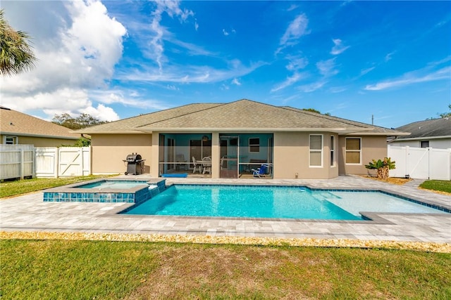 view of swimming pool with a patio, a grill, an in ground hot tub, a yard, and a sunroom