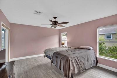 bedroom with light hardwood / wood-style floors and ceiling fan