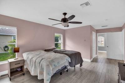 bedroom with ceiling fan and light hardwood / wood-style flooring