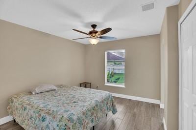 bedroom featuring wood-type flooring and ceiling fan