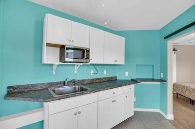 kitchen featuring white cabinetry and sink