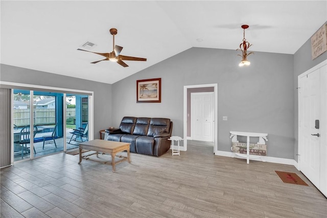 living room with vaulted ceiling, ceiling fan, and light hardwood / wood-style floors