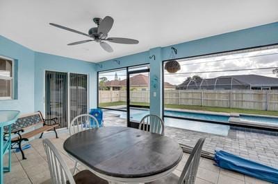 view of patio with a fenced in pool and ceiling fan