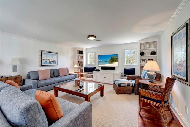 707 Grove Pl, Vero Beach, FL 32963 - living room featuring built in shelves, ornamental molding, baseboards, and wood finished floors
