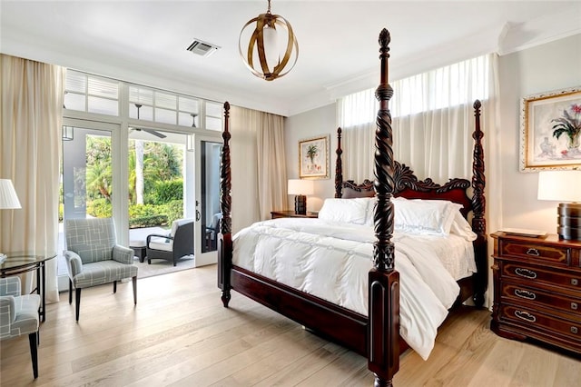 707 Grove Pl, Vero Beach, FL 32963 - bedroom with crown molding, access to exterior, and light wood-type flooring