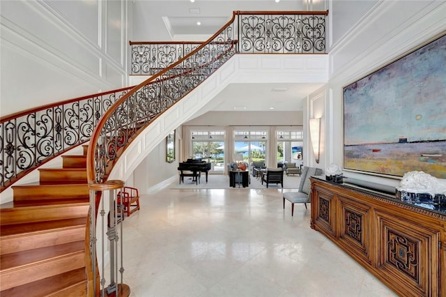 707 Grove Pl, Vero Beach, FL 32963 - stairway with a towering ceiling and crown molding