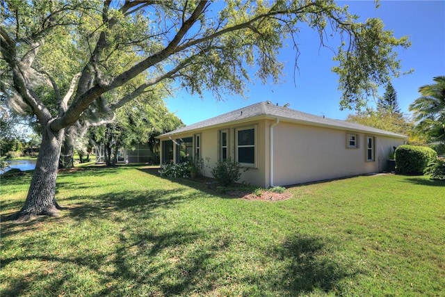 view of home's exterior featuring a lawn and stucco siding