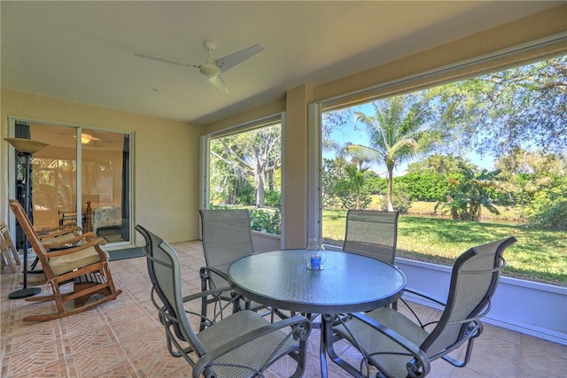 sunroom featuring ceiling fan