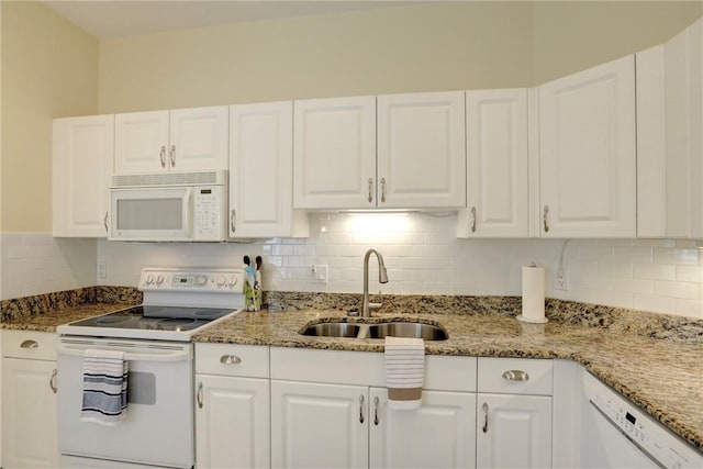 kitchen featuring a sink, white appliances, and white cabinets