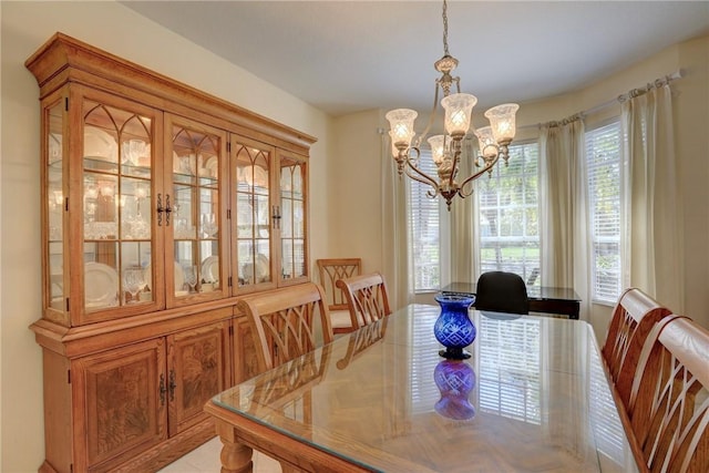 dining space featuring a notable chandelier