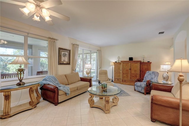 living room featuring light tile patterned flooring, a ceiling fan, and visible vents