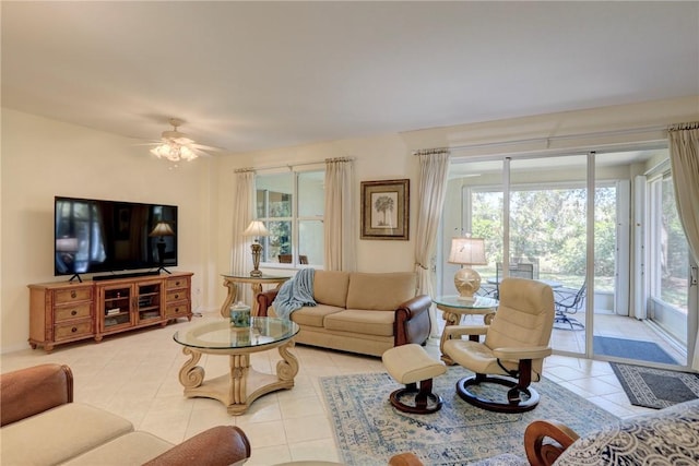 living area with light tile patterned flooring and a ceiling fan