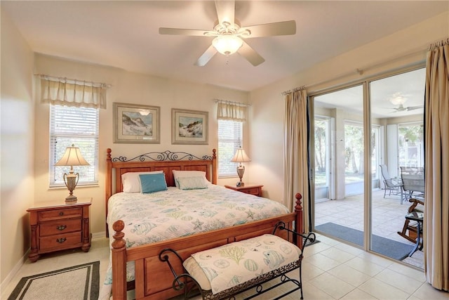 bedroom with multiple windows, baseboards, and access to outside