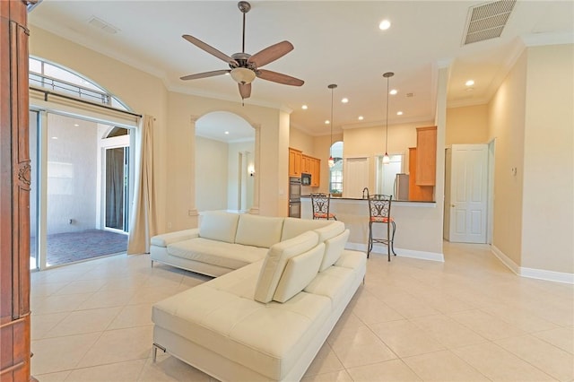 6124 57th Ct, Vero Beach, FL 32967 - living area with ceiling fan, arched walkways, light tile patterned floors, crown molding, and baseboards