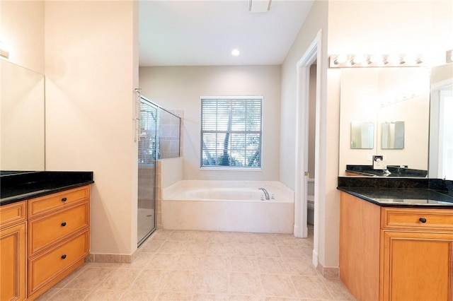 6124 57th Ct, Vero Beach, FL 32967 - full bathroom featuring toilet, a stall shower, a bath, vanity, and tile patterned floors