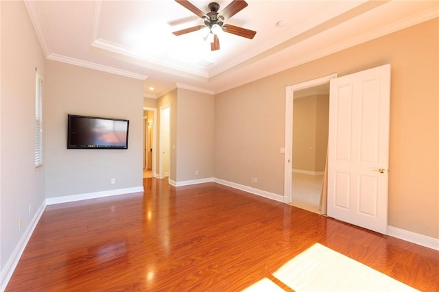 6124 57th Ct, Vero Beach, FL 32967 - empty room with ceiling fan, a tray ceiling, ornamental molding, wood finished floors, and baseboards
