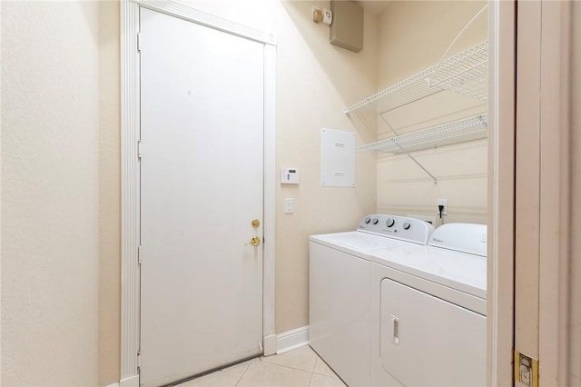 6124 57th Ct, Vero Beach, FL 32967 - laundry room with washer and dryer, light tile patterned floors, and baseboards