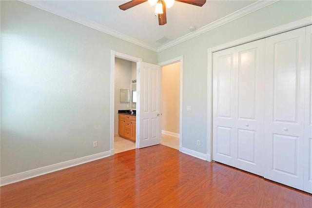 6124 57th Ct, Vero Beach, FL 32967 - unfurnished bedroom with a closet, light wood-type flooring, ornamental molding, baseboards, and a ceiling fan