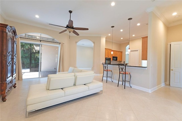 6124 57th Ct, Vero Beach, FL 32967 - living room featuring recessed lighting, arched walkways, crown molding, a ceiling fan, and light tile patterned flooring