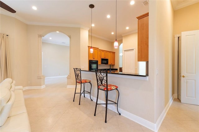 6124 57th Ct, Vero Beach, FL 32967 - kitchen featuring black appliances, arched walkways, ornamental molding, dark countertops, and open floor plan