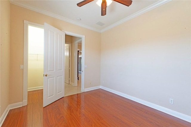 6124 57th Ct, Vero Beach, FL 32967 - spare room with a ceiling fan, wood finished floors, crown molding, and baseboards