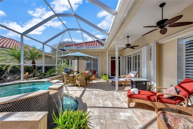 view of patio featuring glass enclosure and ceiling fan