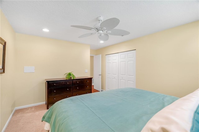 carpeted bedroom with a closet and ceiling fan