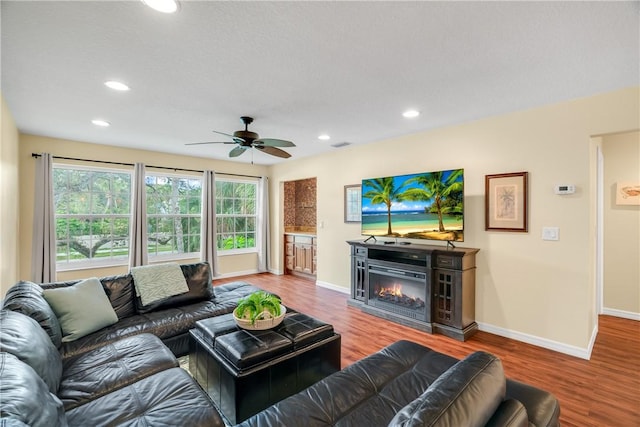 living room with hardwood / wood-style floors and ceiling fan