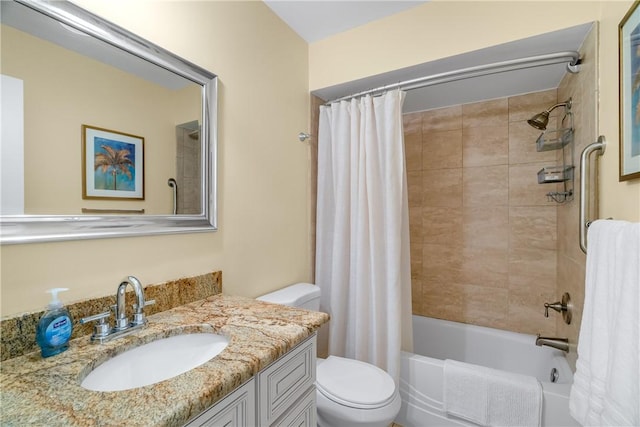 full bathroom featuring vanity, shower / tub combo with curtain, and toilet