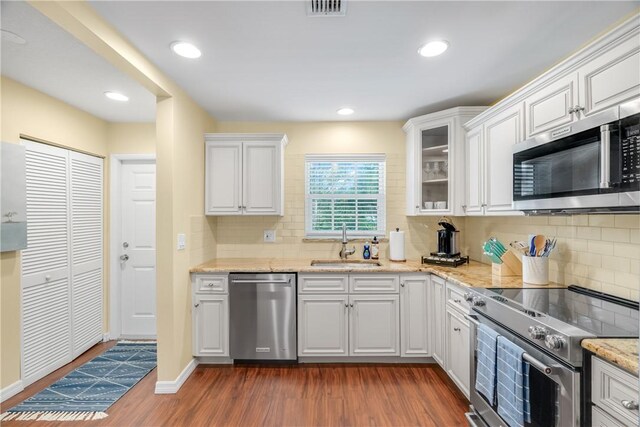 kitchen with white cabinetry, sink, dark hardwood / wood-style flooring, and stainless steel appliances