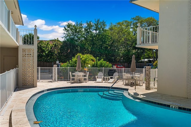 view of swimming pool featuring a patio area