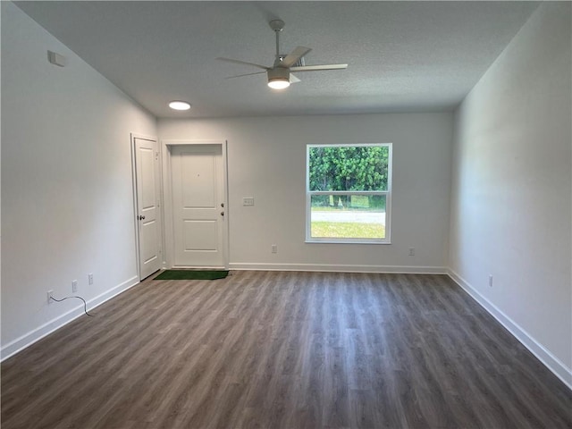 spare room featuring dark hardwood / wood-style floors and ceiling fan