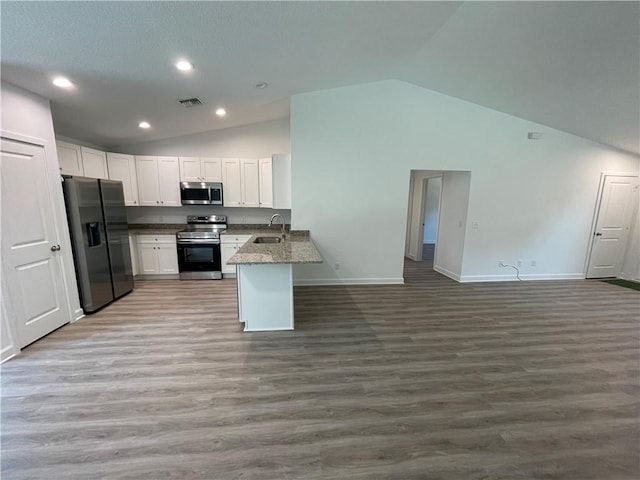 kitchen with white cabinetry, light hardwood / wood-style floors, kitchen peninsula, and appliances with stainless steel finishes