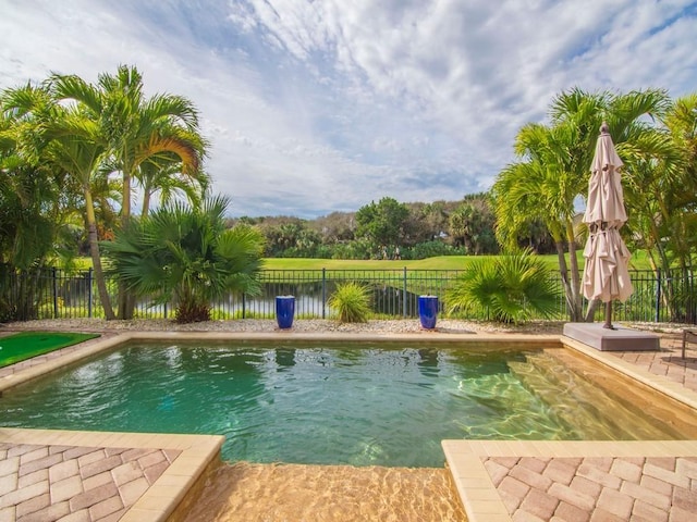 view of swimming pool with a water view and a patio