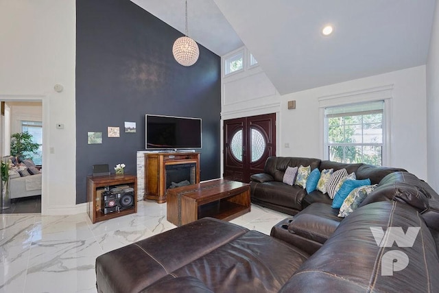 living area featuring high vaulted ceiling, recessed lighting, marble finish floor, and baseboards