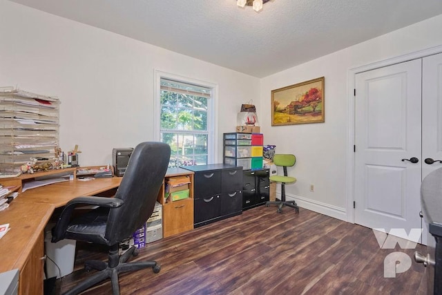 office with dark wood-style floors, baseboards, and a textured ceiling