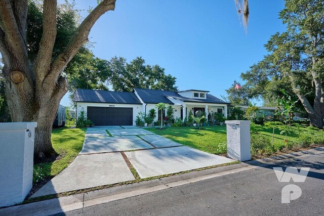 view of front of home with a front lawn and a garage