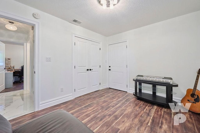 interior space with dark hardwood / wood-style flooring and a textured ceiling