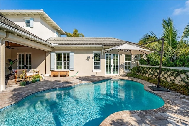 rear view of property featuring a patio area and ceiling fan