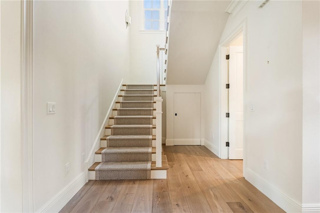 stairs featuring wood-type flooring