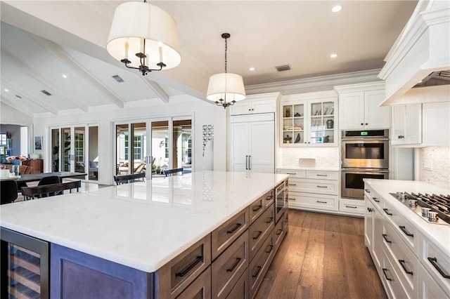 kitchen featuring wine cooler, stainless steel appliances, decorative light fixtures, and white cabinets